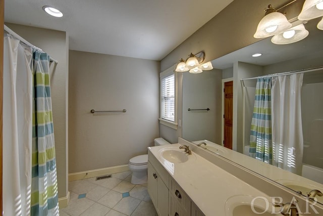 bathroom featuring tile patterned flooring, a sink, visible vents, baseboards, and double vanity