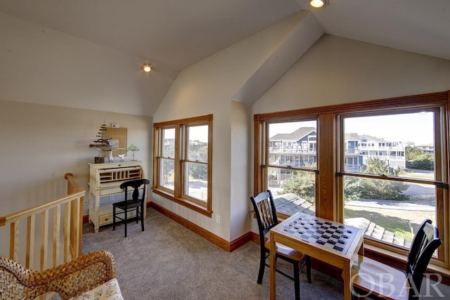 office area featuring carpet, vaulted ceiling, and baseboards