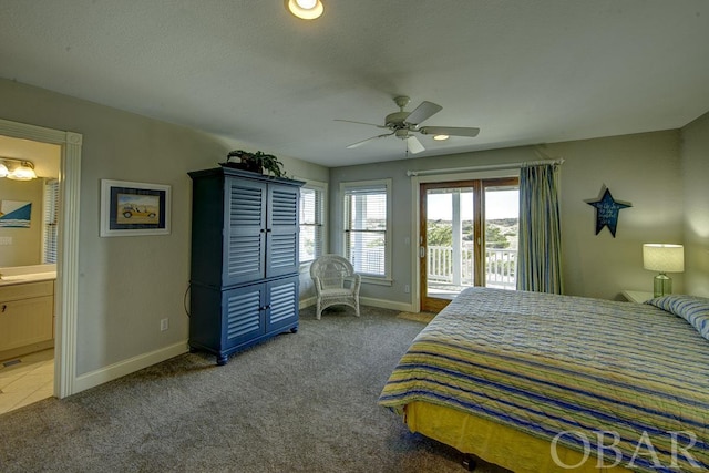 bedroom with access to exterior, connected bathroom, carpet floors, and baseboards