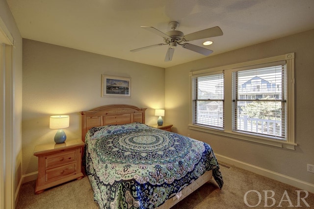 bedroom with light carpet, ceiling fan, and baseboards