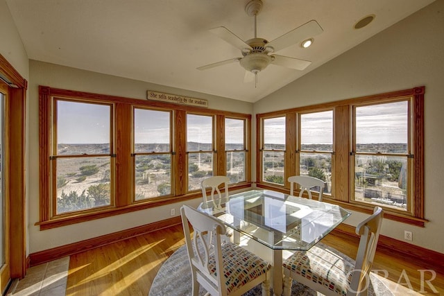 sunroom with lofted ceiling and a ceiling fan