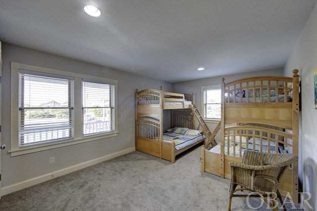 unfurnished bedroom featuring recessed lighting, light colored carpet, and baseboards