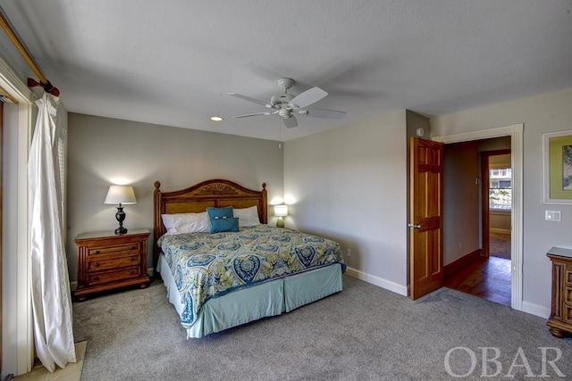 carpeted bedroom with a ceiling fan and baseboards