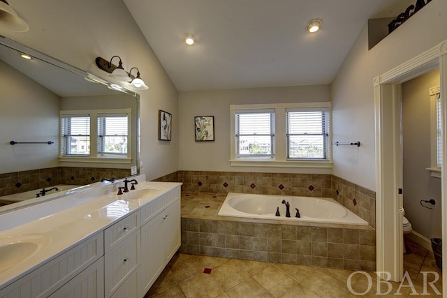 full bathroom with a garden tub, toilet, vaulted ceiling, a sink, and tile patterned flooring