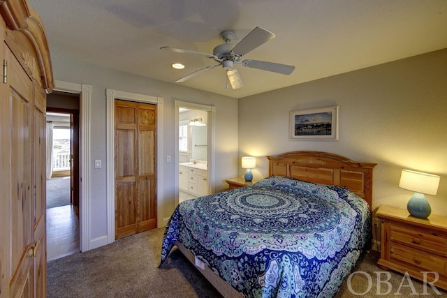 bedroom featuring ensuite bath, carpet, baseboards, and ceiling fan