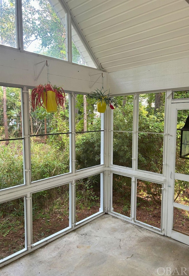 unfurnished sunroom with a wealth of natural light and lofted ceiling