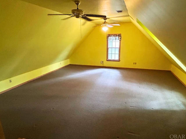 additional living space with lofted ceiling, visible vents, carpet flooring, ceiling fan, and baseboards