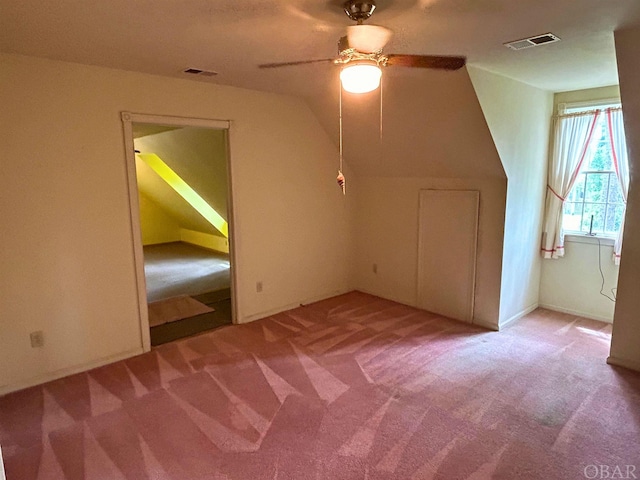 bonus room with light carpet, vaulted ceiling, and visible vents