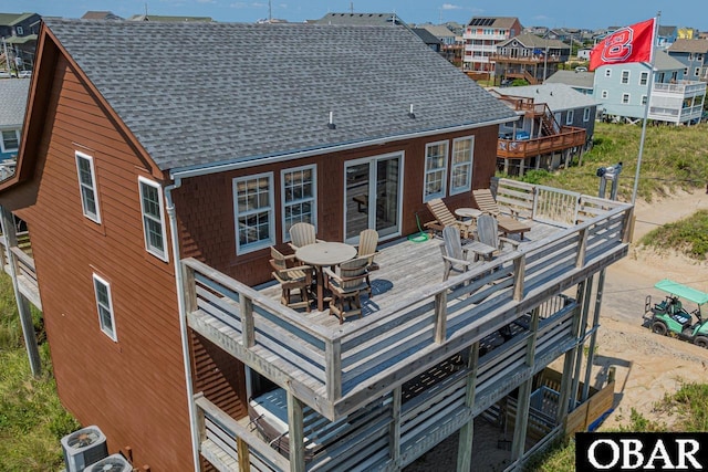 back of house with a deck, a shingled roof, outdoor dining area, and central AC unit