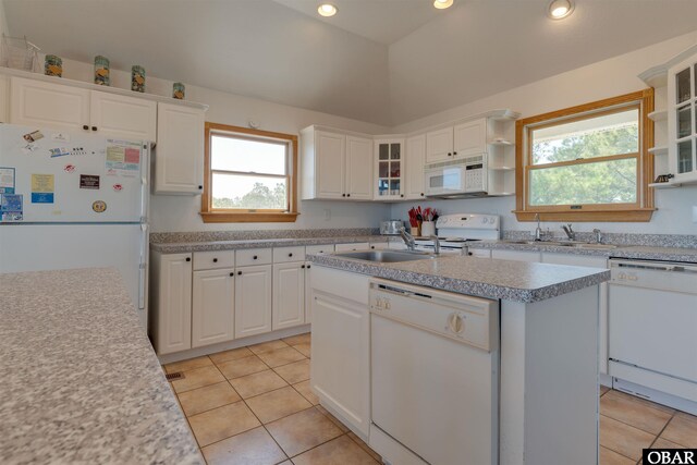 1219 Bismark Dr Lot # 107, Corolla, NC 27927 - kitchen with white appliances, an island with sink, light tile patterned floors, light countertops, and recessed lighting