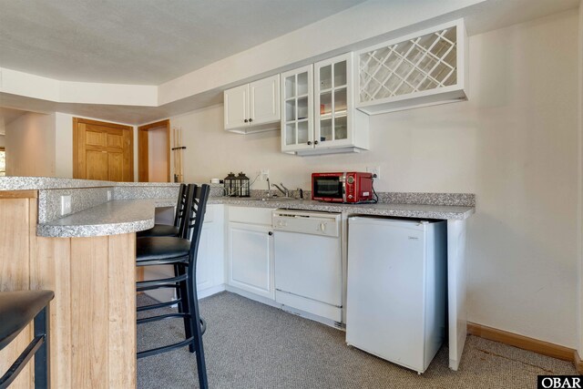 1219 Bismark Dr Lot # 107, Corolla, NC 27927 - kitchen with white dishwasher, refrigerator, and light countertops