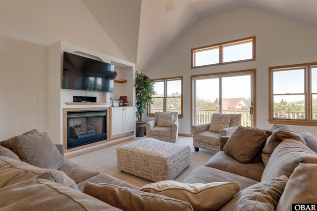 1219 Bismark Dr Lot # 107, Corolla, NC 27927 - living area with light carpet, high vaulted ceiling, a fireplace, plenty of natural light, and a ceiling fan