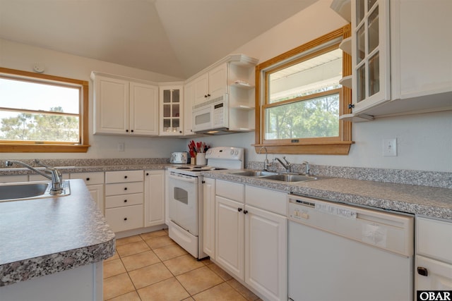 1219 Bismark Dr Lot # 107, Corolla, NC 27927 - kitchen with white appliances, light tile patterned flooring, white cabinets, lofted ceiling, and glass insert cabinets