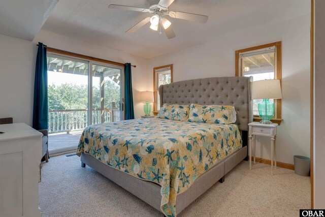 1219 Bismark Dr Lot # 107, Corolla, NC 27927 - carpeted bedroom featuring access to exterior, multiple windows, and ceiling fan