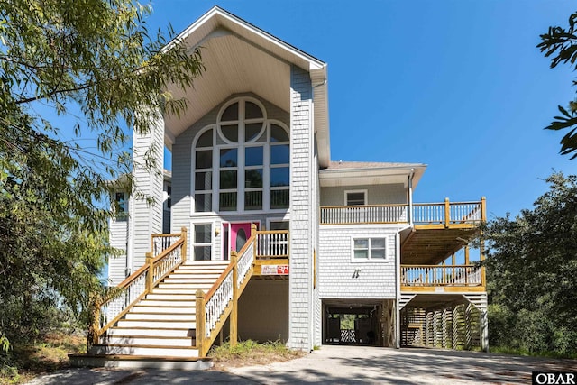 1219 Bismark Dr Lot # 107, Corolla, NC 27927 - view of front of house with a carport, stairway, a balcony, driveway, and a shingled roof