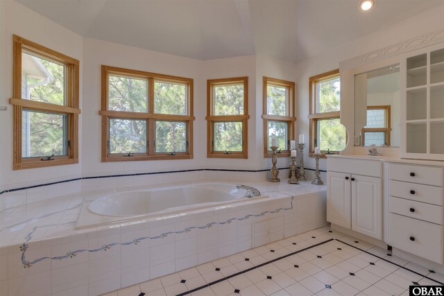 1219 Bismark Dr Lot # 107, Corolla, NC 27927 - bathroom featuring vanity, a bath, tile patterned floors, recessed lighting, and lofted ceiling