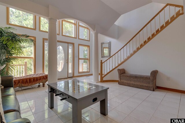 1219 Bismark Dr Lot # 107, Corolla, NC 27927 - entryway with ornate columns, light tile patterned flooring, stairs, and high vaulted ceiling