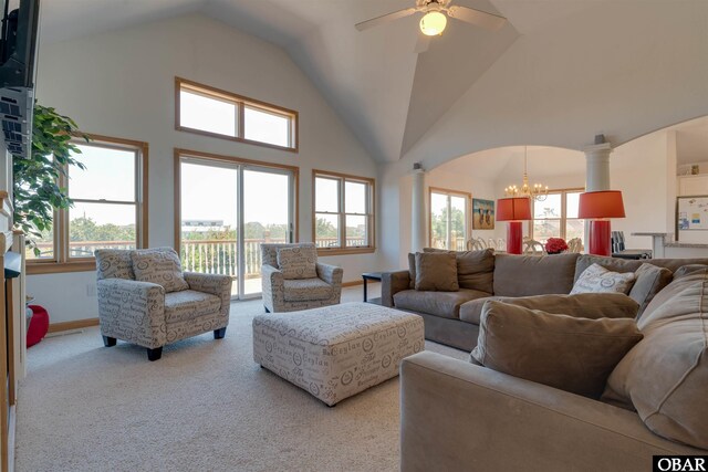 1219 Bismark Dr Lot # 107, Corolla, NC 27927 - carpeted living room featuring decorative columns, a chandelier, a ceiling fan, arched walkways, and high vaulted ceiling