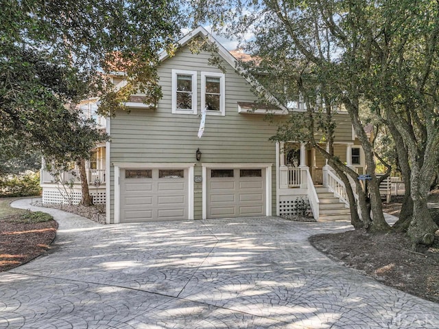 view of front of property featuring a garage and decorative driveway