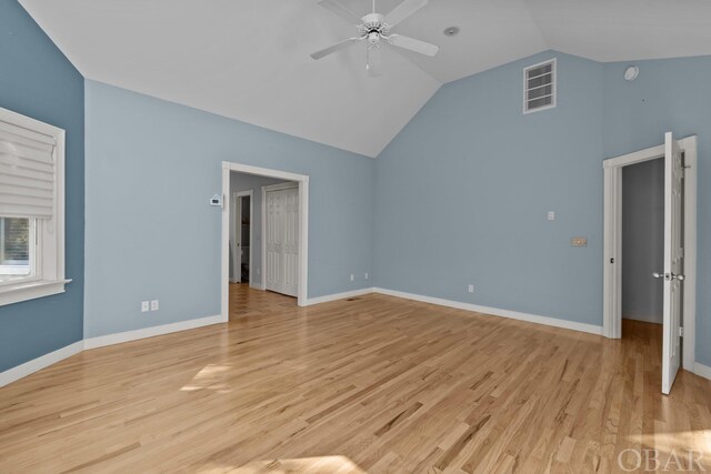 interior space featuring a ceiling fan, light wood-style flooring, visible vents, and baseboards