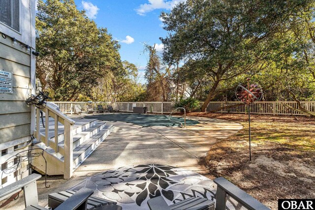 view of swimming pool featuring a patio area and fence