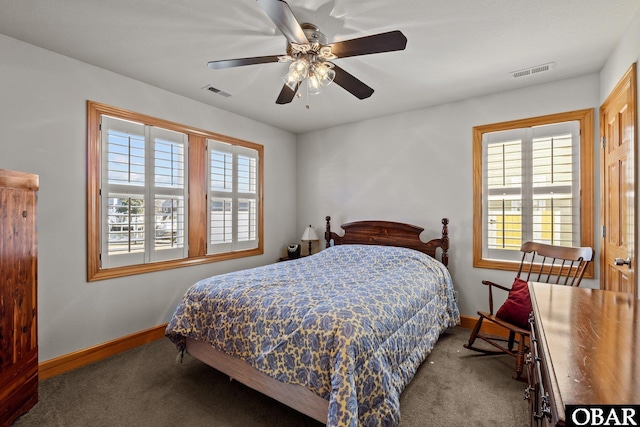 carpeted bedroom featuring visible vents, multiple windows, and baseboards