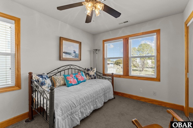 carpeted bedroom featuring baseboards, visible vents, and ceiling fan