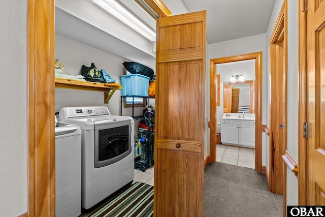 laundry room with light tile patterned floors, a sink, light carpet, and separate washer and dryer