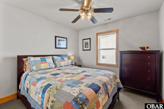 carpeted bedroom featuring visible vents, baseboards, and a ceiling fan