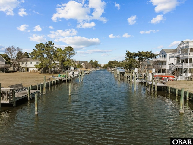 dock area featuring a water view and a residential view