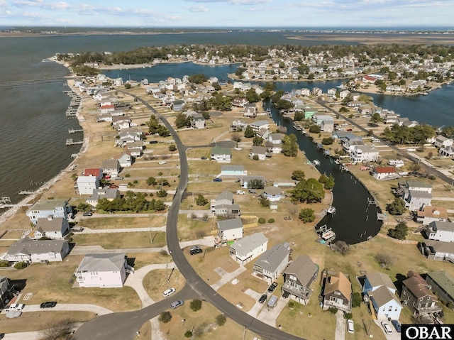 drone / aerial view with a water view and a residential view