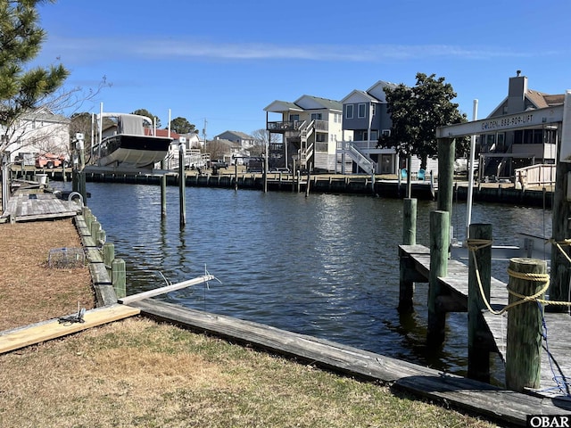 dock area with a water view and a residential view