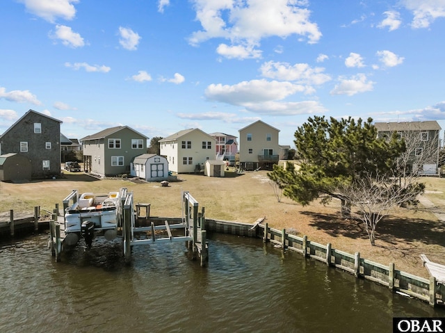 dock area with a residential view, a water view, and boat lift