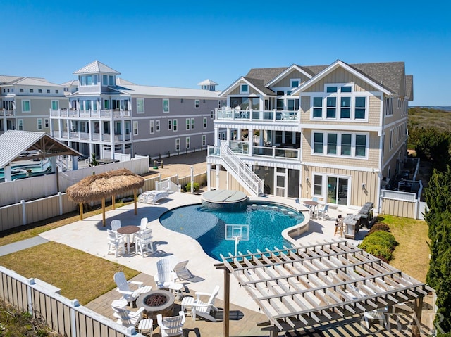 community pool featuring a fire pit, a gazebo, a patio, and a fenced backyard