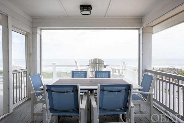 sunroom / solarium with a water view