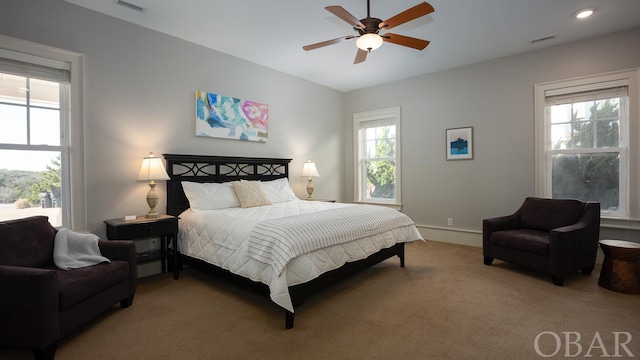 bedroom with a ceiling fan, carpet, visible vents, and baseboards