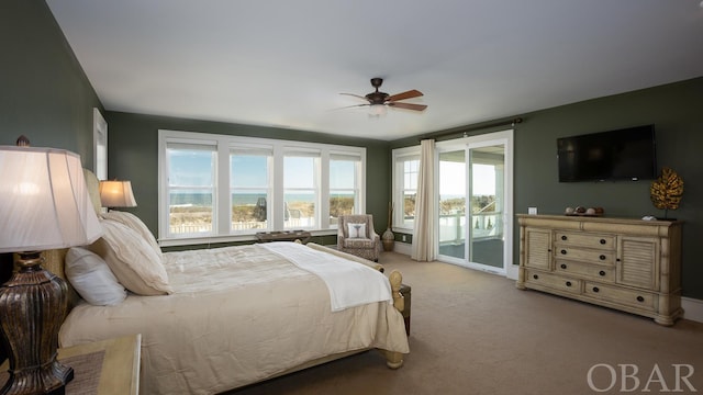 bedroom featuring access to exterior, a ceiling fan, and light colored carpet