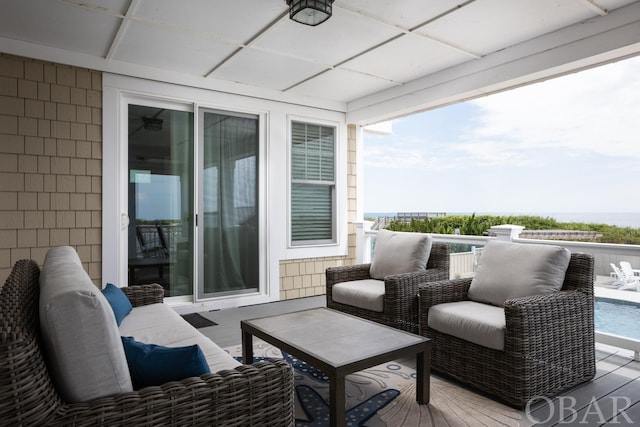 view of wooden balcony with a sunroom, outdoor lounge area, and a wooden deck