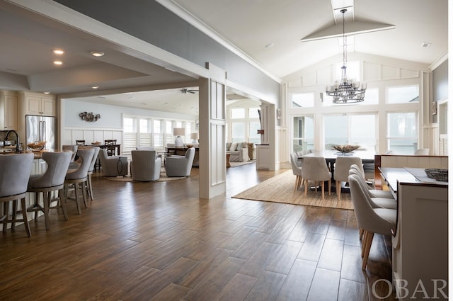 dining space featuring high vaulted ceiling, recessed lighting, ceiling fan with notable chandelier, dark wood-type flooring, and crown molding