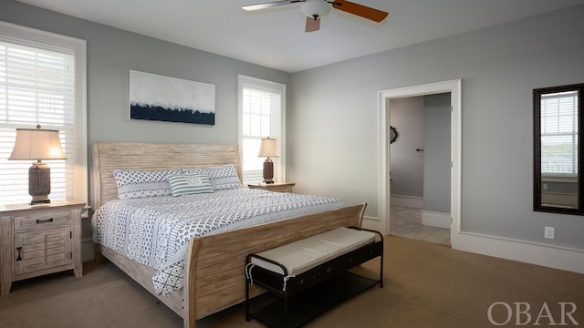 bedroom featuring baseboards, a ceiling fan, and light colored carpet