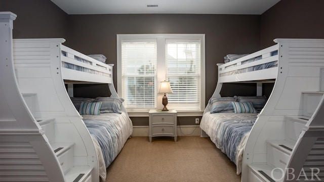 bedroom with light carpet and visible vents