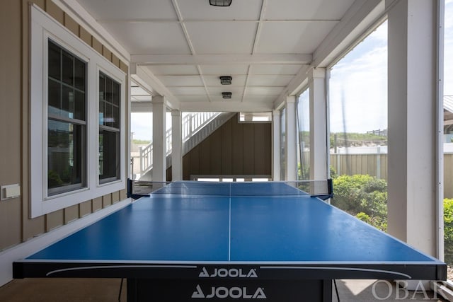 recreation room featuring a drop ceiling and a wealth of natural light