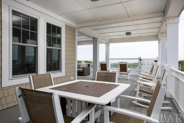 wooden deck featuring outdoor dining area