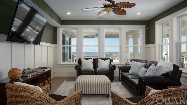 sunroom / solarium featuring a ceiling fan