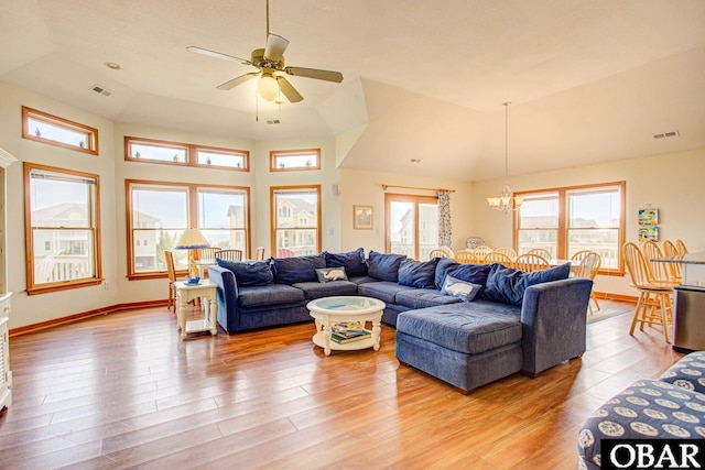 living area with visible vents, baseboards, and wood finished floors