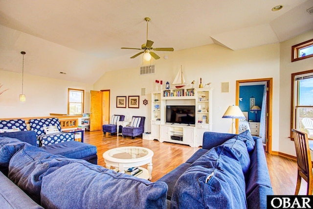 living room featuring baseboards, visible vents, and wood finished floors