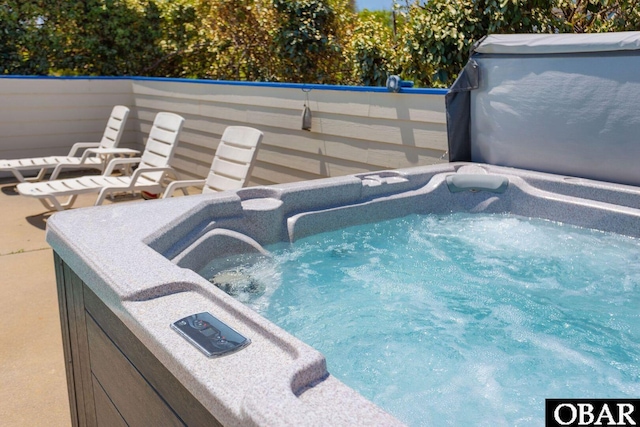 view of pool with a hot tub