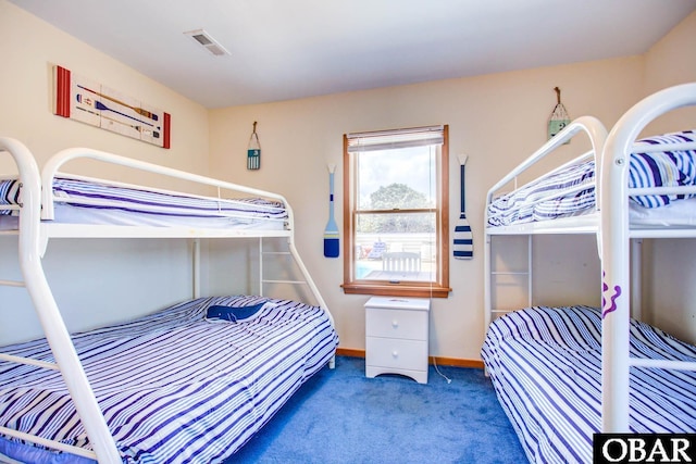 carpeted bedroom featuring visible vents and baseboards