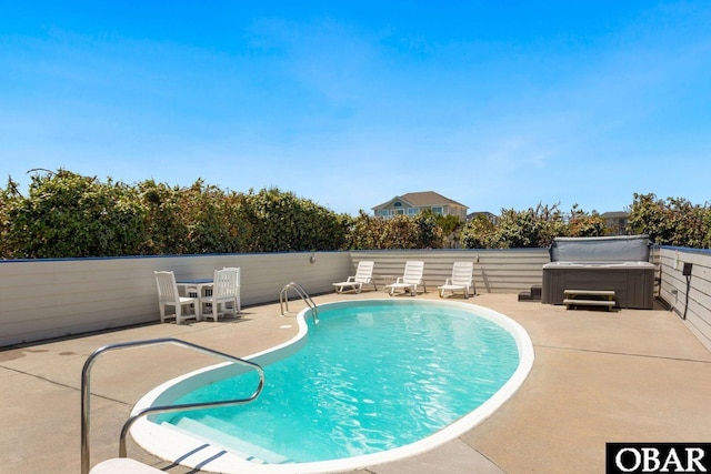 view of pool with a patio, a fenced in pool, and a hot tub