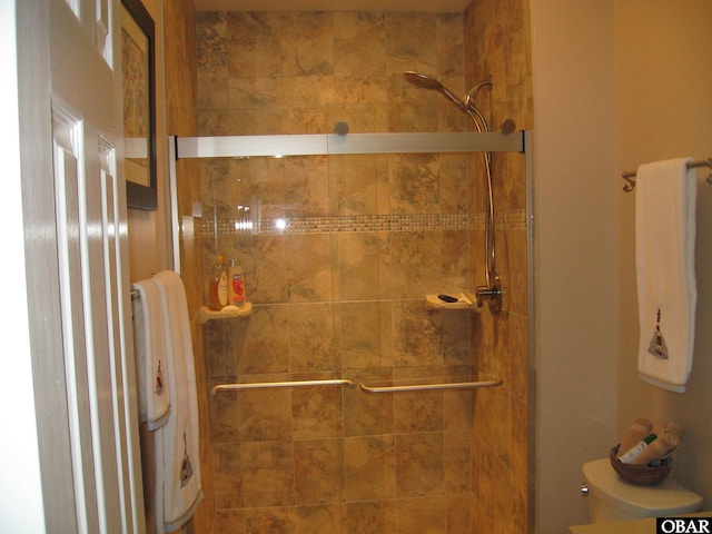 full bathroom with a shower stall and toilet